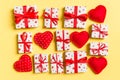 Top view of white gift boxes and red textile hearts on colorful background. Valentine`s Day concept Royalty Free Stock Photo
