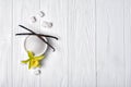 Top view of white granulated and cubes sugar with vanilla sticks and flower