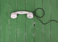 Top view White handset vintage phone green wood textured Royalty Free Stock Photo