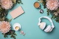 Top view of white headphones, gift box, flowers and cup of coffee on cyan background. Cyber Monday, Black Friday