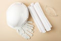 Top view white helmet, gloves, plan, drawings, construction glasses on beige background, development of construction object