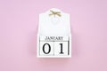 Top view white January 01 wooden cube calendar on a pink background. New Year concept Royalty Free Stock Photo