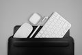 Top view of white keyboard, mouse, earphones case and pen on light grey background. Royalty Free Stock Photo