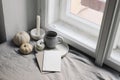 Top view of white little pumpkins, cup of coffee and smoking candle near window. Blank greeting card mockup. Autumn Royalty Free Stock Photo