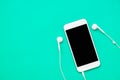 Top view of white mobile phone with headphone Royalty Free Stock Photo