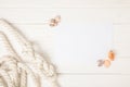 top view of white nautical knotted rope and empty paper with seashells on wooden surface Royalty Free Stock Photo