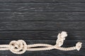 top view of white nautical rope with knots on dark Royalty Free Stock Photo