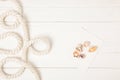 top view of white nautical rope and seashells on empty paper on wooden surface Royalty Free Stock Photo