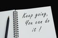 Top view of white notebook with motivational quote on dark background Royalty Free Stock Photo