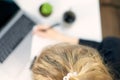 Top view white office desk table with blank notebook, computer laptop keyboard, pen, plant and other office supplies. Coffee cup Royalty Free Stock Photo