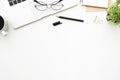 Top view of white office desk table with laptop computer and office supplies. Flay lay image