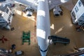 Top view of a white passenger airliner in the aviation hangar. Aircraft under maintenance