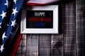Top view of white picture frame with Flag of the United States of America on wooden background.  Independence Day USA, Memorial Royalty Free Stock Photo