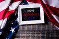 Top view of white picture frame with Flag of the United States of America on wooden background.  Independence Day USA, Memorial Royalty Free Stock Photo