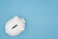 Top view of white piggy bank for money saving isolated on light blue background Royalty Free Stock Photo