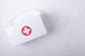 Top view of white plastic first aid kit on the white table.Empty space for text Royalty Free Stock Photo