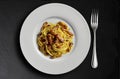 Top view of Plate with spaghetti carbonara on black stone Royalty Free Stock Photo