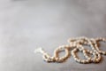 Top view white rosary beads isolated on the grey background Royalty Free Stock Photo