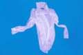 Aerial view of a white shirt that floats on the water of a swimming pool