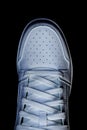 Top view of white sneaker on a black background Royalty Free Stock Photo