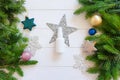 Top view of white spray bottle mockup, fir branches, stars, balls on a white wooden table. Blank label bottle for branding. Royalty Free Stock Photo