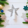 Top view of white spray bottle mockup, fir branches, stars, balls on a white wooden table. Blank label bottle for branding. Royalty Free Stock Photo