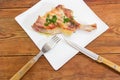 Grilled pork loin on bone on dish, fork and knife Royalty Free Stock Photo