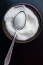 Top view on white Sugar in bowl on black. Closeup