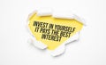 Top view of white torn paper and the text Invest in Yourself It pays the best interest on a yellow background Royalty Free Stock Photo