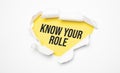 Top view of white torn paper and the text Know Your Role on a yellow background Royalty Free Stock Photo
