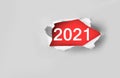Top view of white torn paper and the text `2021` on a red background...