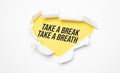 Top view of white torn paper and the text Take a break,take a breath on a yellow background Royalty Free Stock Photo