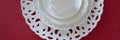 Top view of white vintage tableware set on red background. Empty porcelain plates Royalty Free Stock Photo