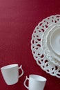 Top view of white vintage tableware set on red background. Empty porcelain plates Royalty Free Stock Photo