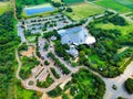 Top view of a white windmill and a building surrounded by many parked cars Royalty Free Stock Photo