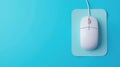 Top view of wired mouse on mousepad with blue background