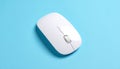 Top View of a White Wireless Computer Mouse on a Blue Surface wireless mouse technology Royalty Free Stock Photo