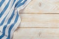 Top view on a white wooden table with a linen kitchen towel or textile napkin. a tablecloth on a light wood countertop Royalty Free Stock Photo