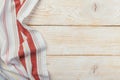 Top view on a white wooden table with a linen kitchen towel or textile napkin. a tablecloth on a light wood countertop Royalty Free Stock Photo