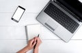 Top view on white wooden table with open blank laptop computer. Royalty Free Stock Photo