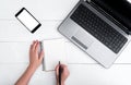 Top view on white wooden table with open blank laptop computer Royalty Free Stock Photo