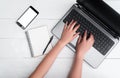 Top view on white wooden table with open blank laptop computer Royalty Free Stock Photo