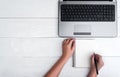 Top view on white wooden table with open blank laptop computer Royalty Free Stock Photo