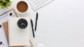 Top view white wooden workspace office desk with computer and office supplies. Flat lay work table with blank notebook, keyboard, Royalty Free Stock Photo