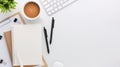 Top view white wooden workspace office desk with computer and office supplies. Flat lay work table with blank notebook, keyboard, Royalty Free Stock Photo