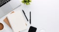 Top view white wooden workspace office desk with computer and office supplies. Flat lay work table with blank notebook, keyboard, Royalty Free Stock Photo