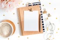 Top view of white working table background with cup of coffee putting on it. Flat lay glasses, flower, golden paper binder clips, Royalty Free Stock Photo