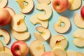 Top view of whole apples and apple slices on blue background