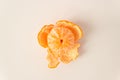 Top view of whole ripe peeled mandarin fruit with orange peels on a white background. Raw food diet and fruitarian. Royalty Free Stock Photo