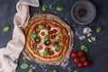 Top view of whole vegetarian pizza with mushrooms, basil, tomatoes, and cheese